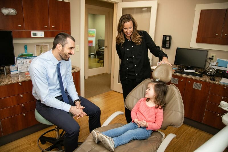 Green Dental examining child for dental sealants